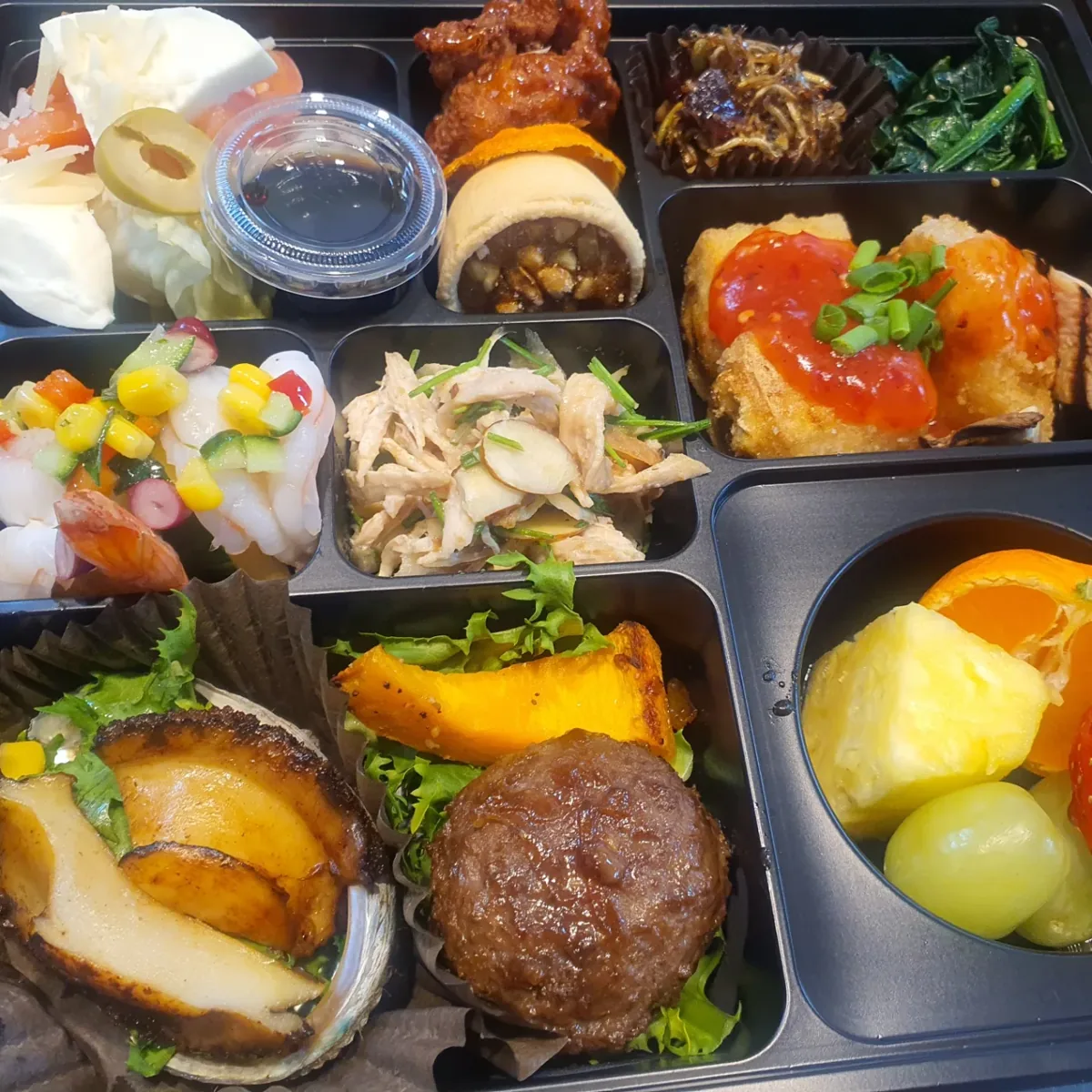 연예인 서포터즈 모임 도시락 구성 진행 중 반찬과 과일 배치를 정리한 모습